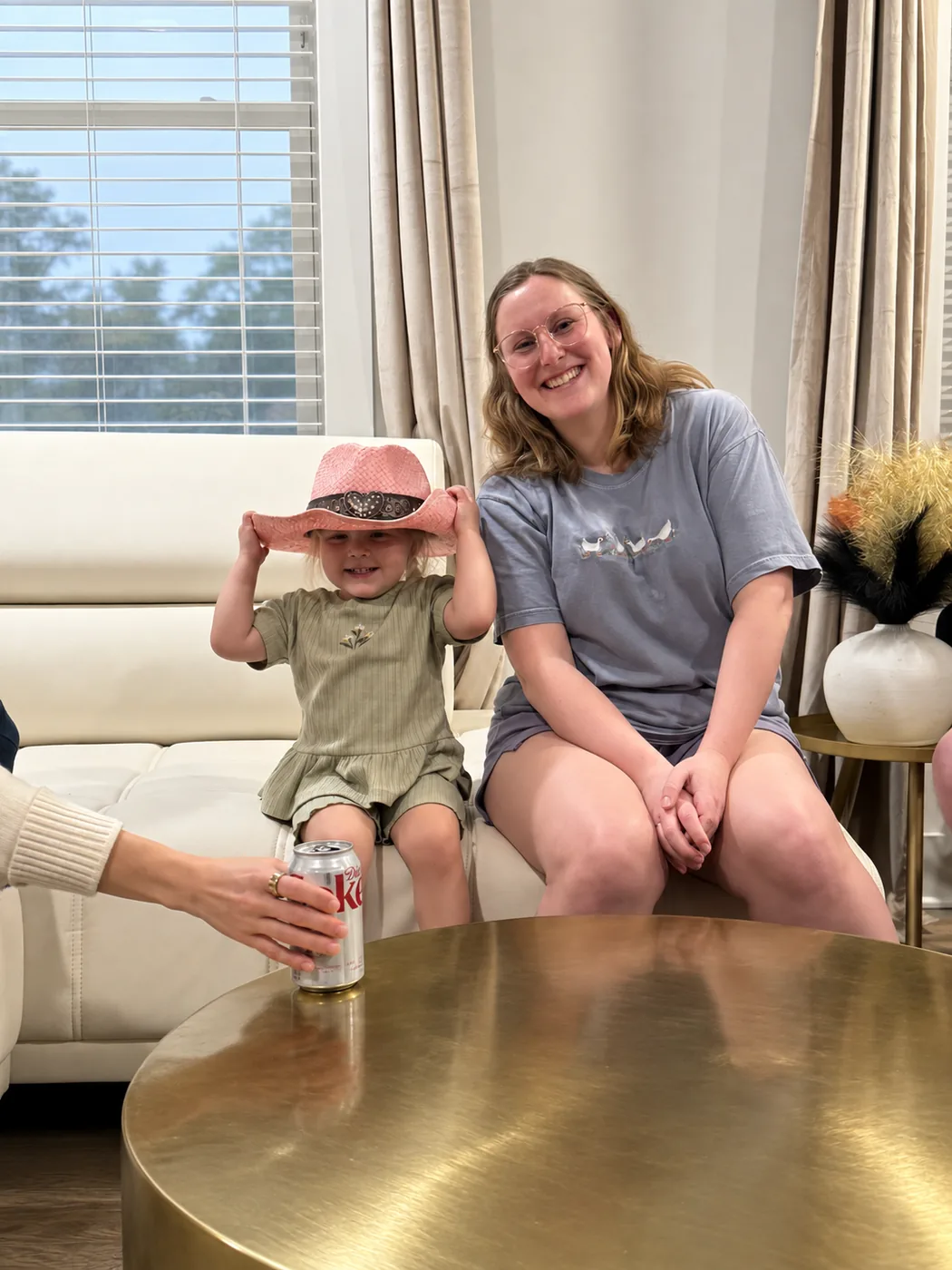 Two of the team and a toddler in a cowboy hat hanging out over drinks.