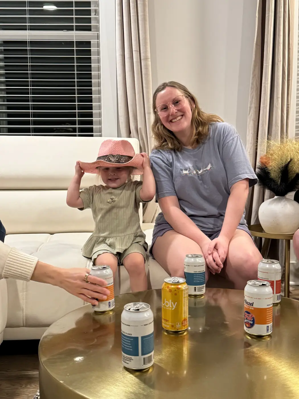 Two of the team and a toddler in a cowboy hat hanging out over drinks.