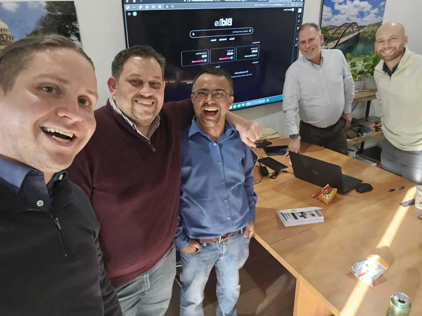 Five of the team around a monitor running Bidlo.