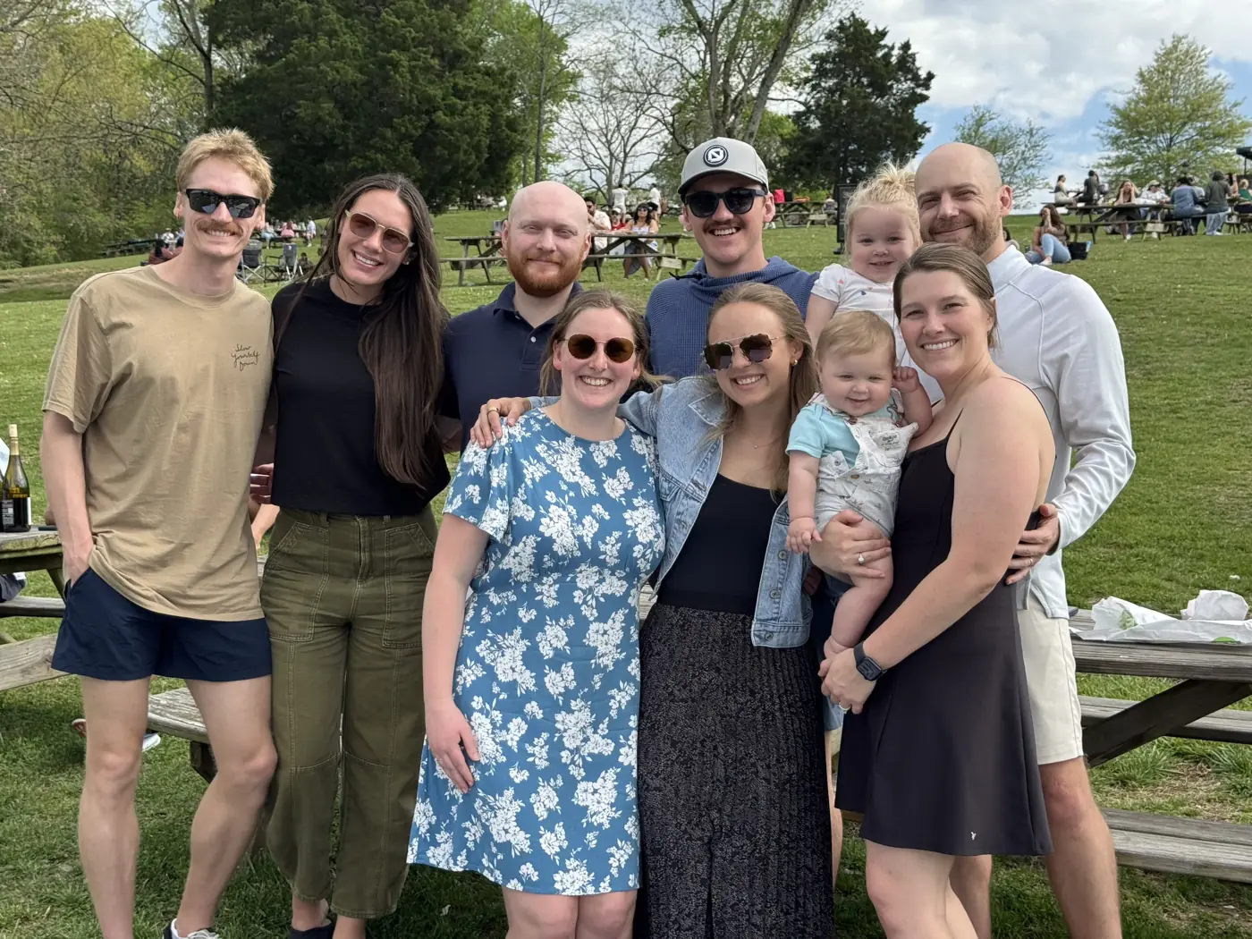 The team and their families together at a park picnic.